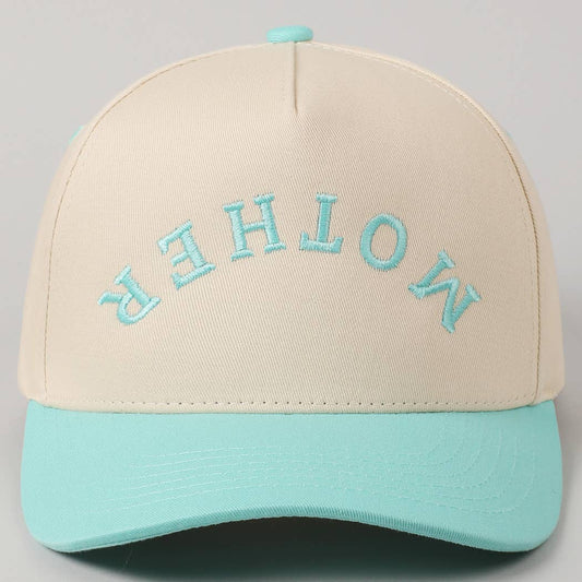 A beige and mint green trucker hat with 'MOTHER' embroidered in blue on the front.